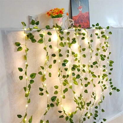 HighPeak GlowVine Lights draped with warm LED fairy-lit ivy vines on a white curtain for cozy decor ambiance