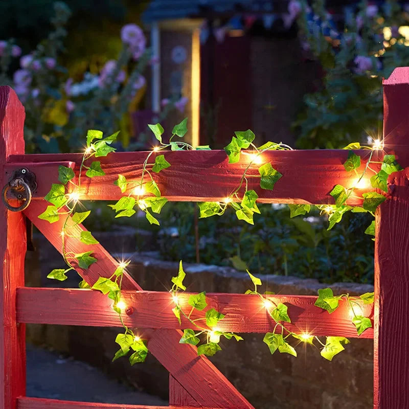 HighPeak GlowVine Lights wrapped on a red wooden garden gate with warm LED fairy-lit ivy for cozy outdoor ambiance