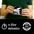 HighPeak Toilet Timer – Funny Bathroom Gift with iconic black and white design held in hands, 5-minute sand timer shown