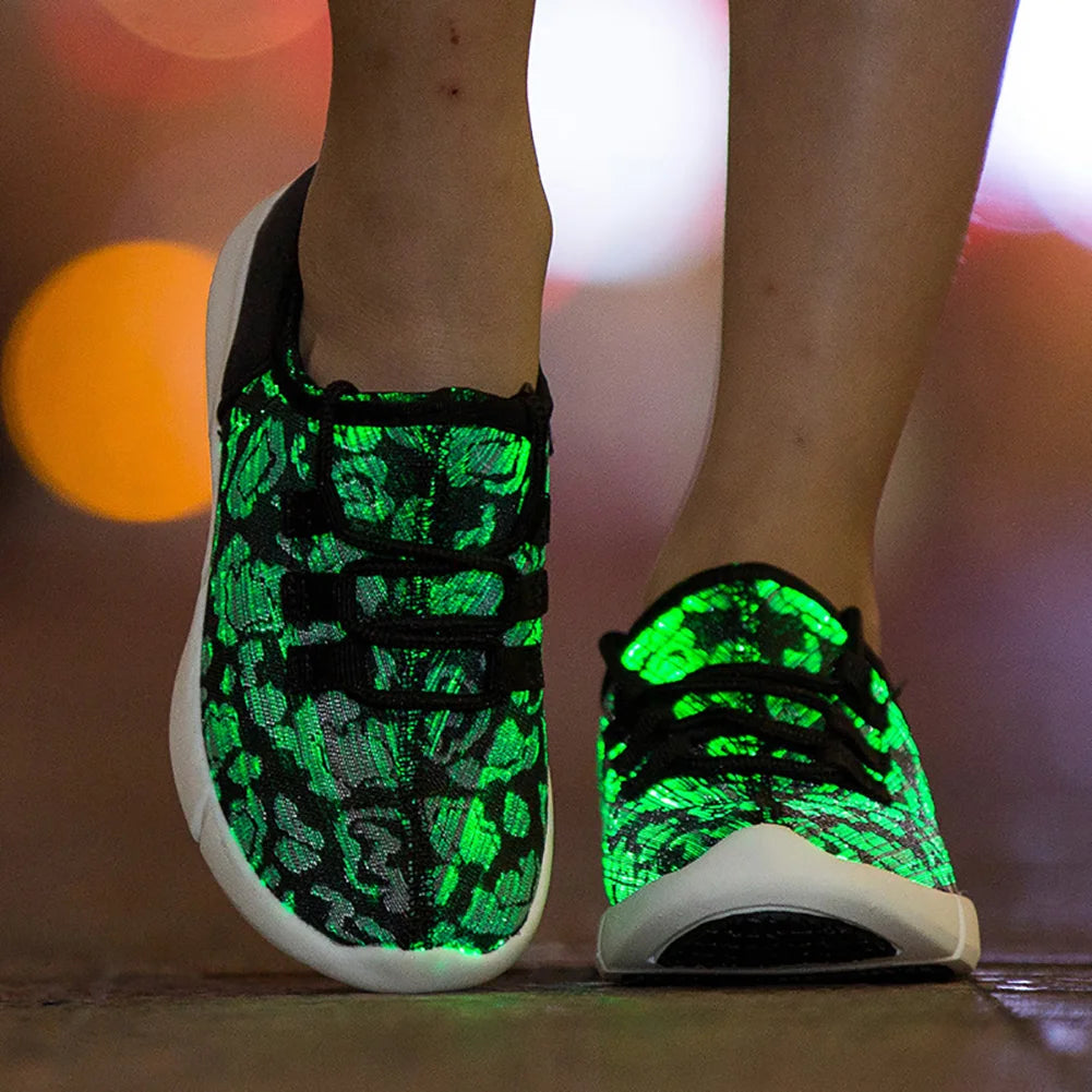 HighPeak Glowstride Sneakers glowing green with fiber optic LED lights on city street at night with black laces