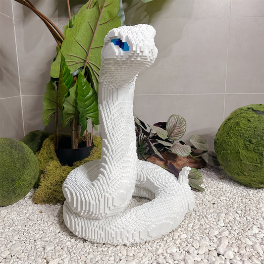 SerpentMaster white cobra building set displayed in zen garden setting with tropical plants and moss spheres - HighPeak design