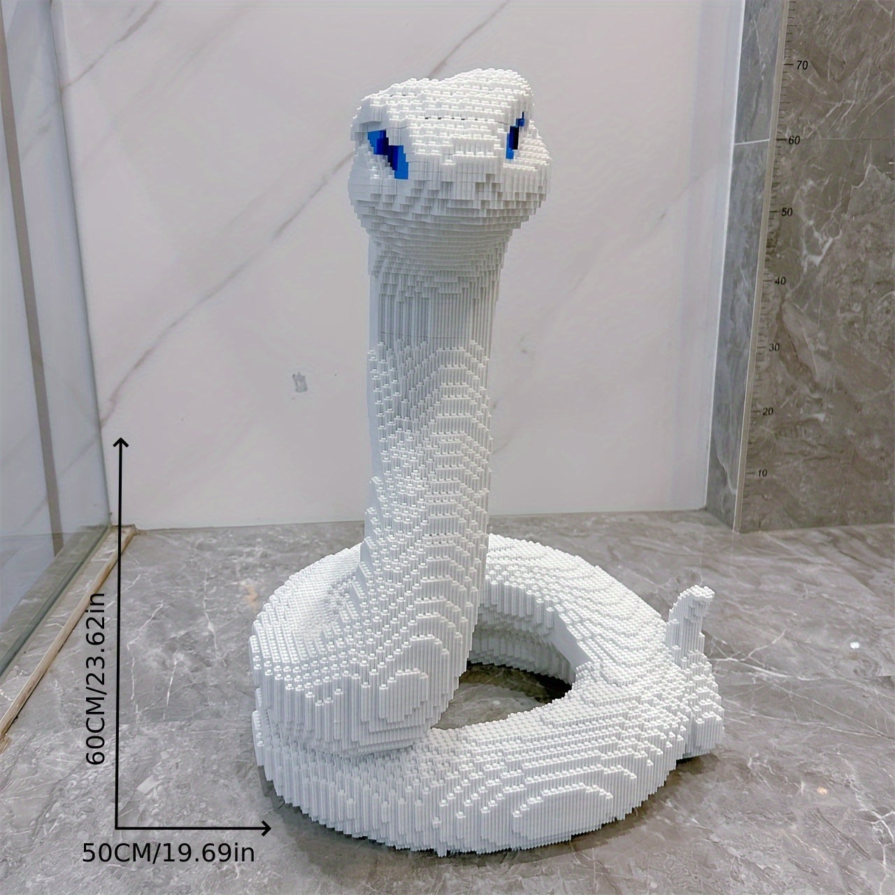 SerpentMaster white coiled snake building set with blue eyes in striking pose on marble surface - HighPeak collectible display