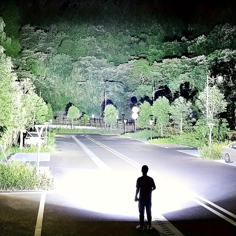 ShadowBreaker tactical flashlight illuminating dark road and trees with intense bright beam, demonstrating powerful 10000 lumen output