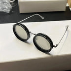 ShiftLens round adaptive sunglasses with silver frames and adjustable lenses on white surface - modern eyewear design