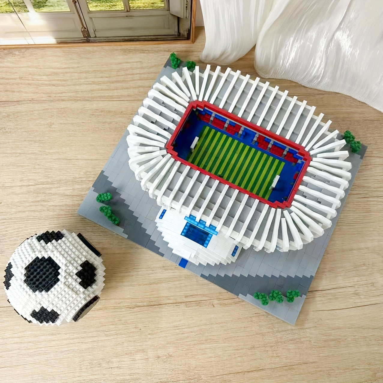 StadiumMaster football stadium building set with 3D soccer ball model displaying detailed white stands and green turf field