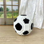 StadiumMaster soccer ball building set in classic black and white blocks displayed on wooden surface near window