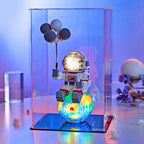 Starlight Voyager illuminated astronaut figure with balloons on glowing cosmic base in display case - space-themed desk decor