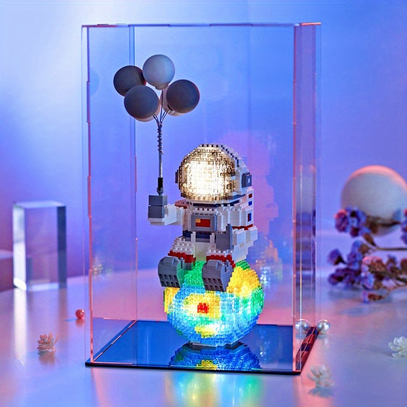 Starlight Voyager illuminated astronaut figure with balloons on glowing cosmic base in display case - space-themed desk decor