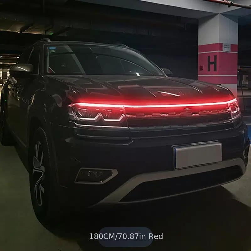 StrikeLine LED hood light strip illuminating black SUV with bright red glow in dark parking garage - modern car lighting upgrade