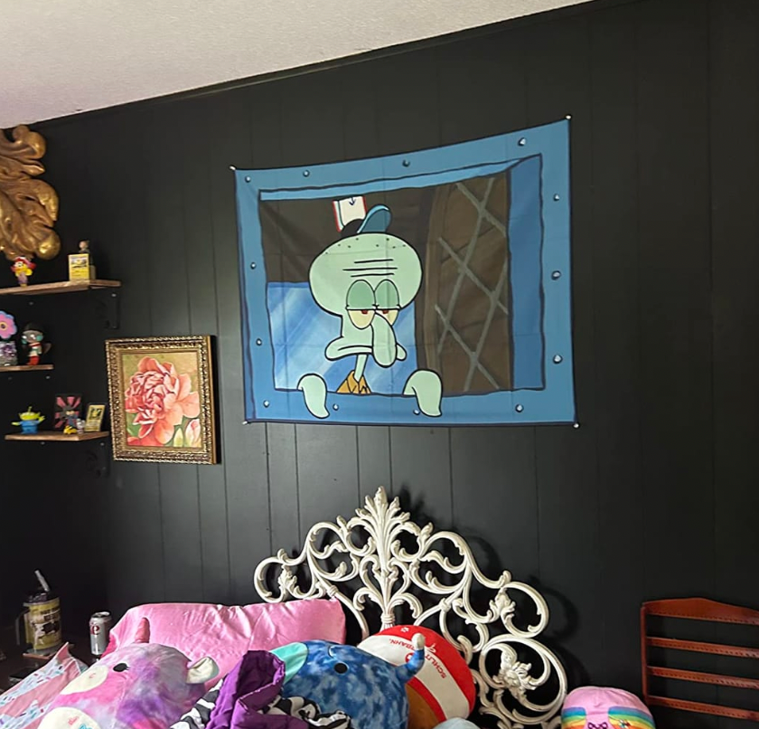 Tentacle Vibes tapestry featuring Squidward window scene on dark wall, ornate white headboard, colorful bedding
