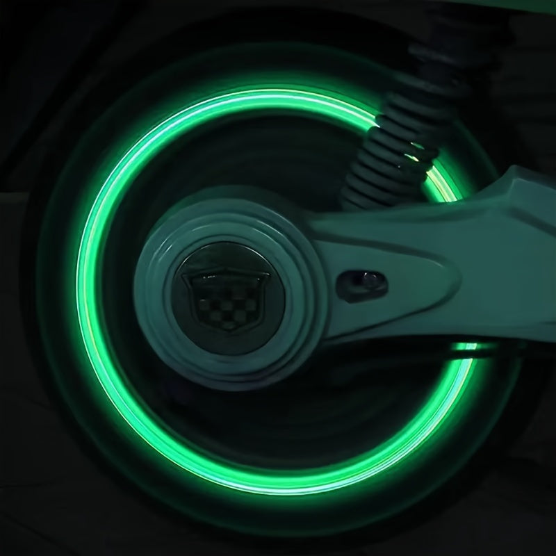 TireValve glow-in-the-dark valve caps creating bright green luminous ring effect on motorcycle wheel at night