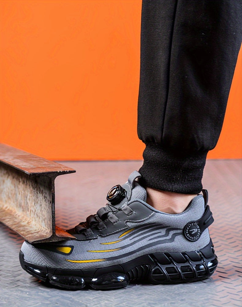 TitanStep shoes in gray and yellow with dial-fit system, shown on steel beam with orange background - industrial safety footwear