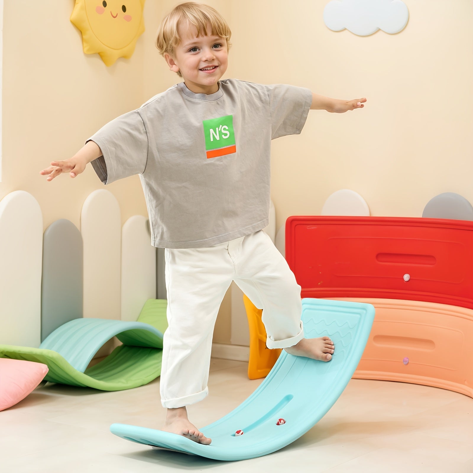 Toddler balancing on HighPeak WobbleJoy™ Kids Balance Board in colorful playroom