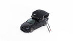 HighPeak Car Roof Tent in black on a black car with telescoping ladder extended, showcasing quick pop-up camping setup.