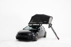 HighPeak Car Roof Tent in black mounted on a black compact car with ladder extended in white studio setting