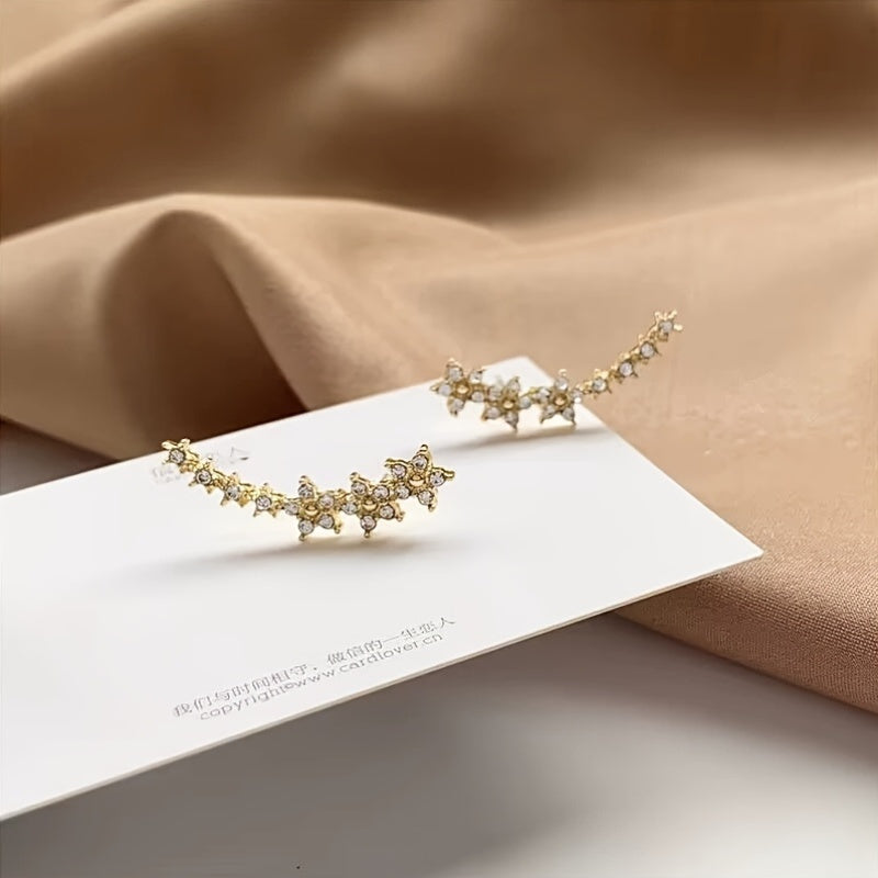 HighPeak Ear Climber Earrings in gold with sparkling rhinestones displayed on white card against beige fabric background