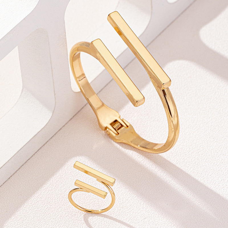 HighPeak Geometric Square Jewelry Set in gold with adjustable square-bar bracelet and matching ring on white textured surface