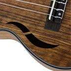 Acoustic Four-String Ukulele close-up of a curved front sound opening beside the bridge and strings.