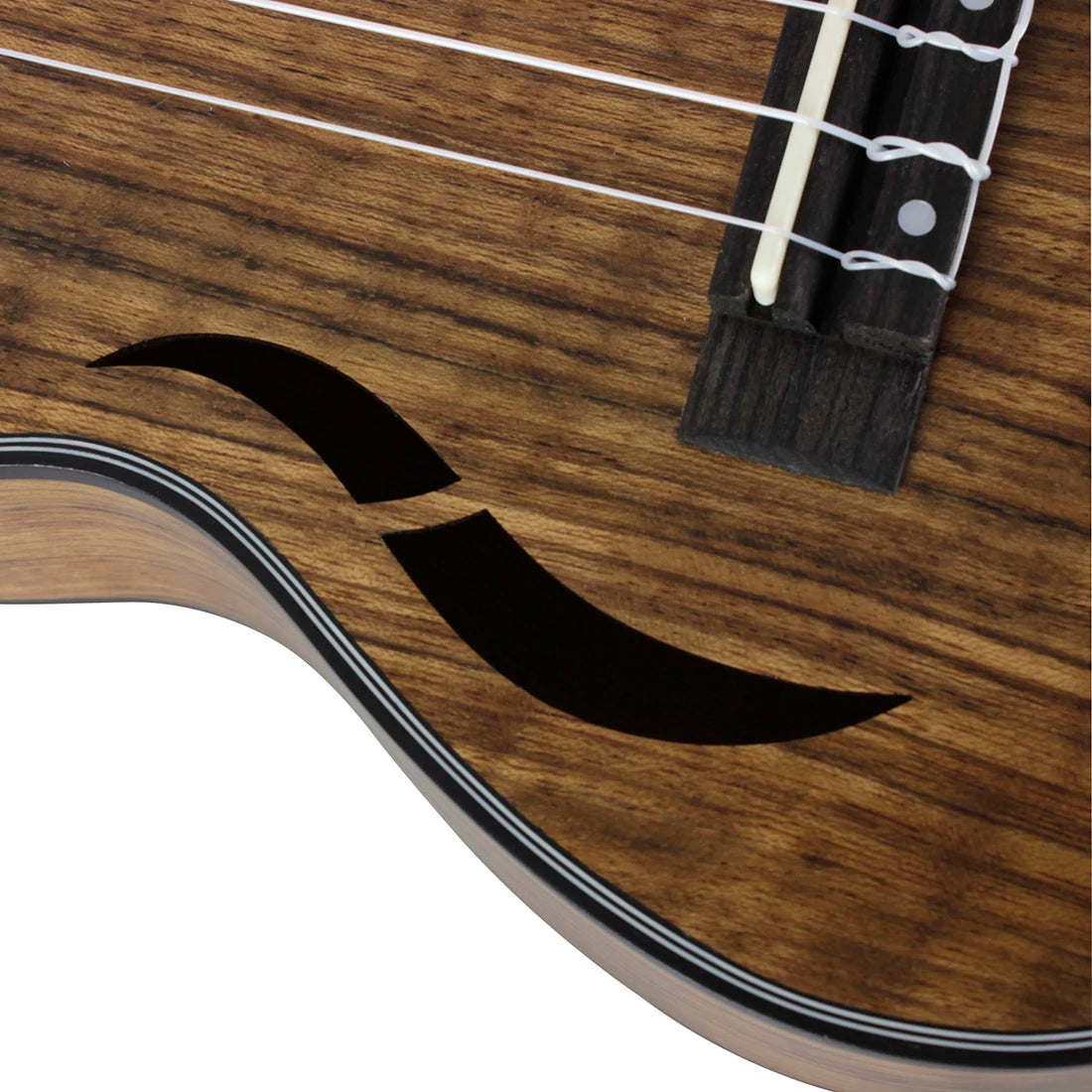 Acoustic Four-String Ukulele close-up of a curved front sound opening beside the bridge and strings.