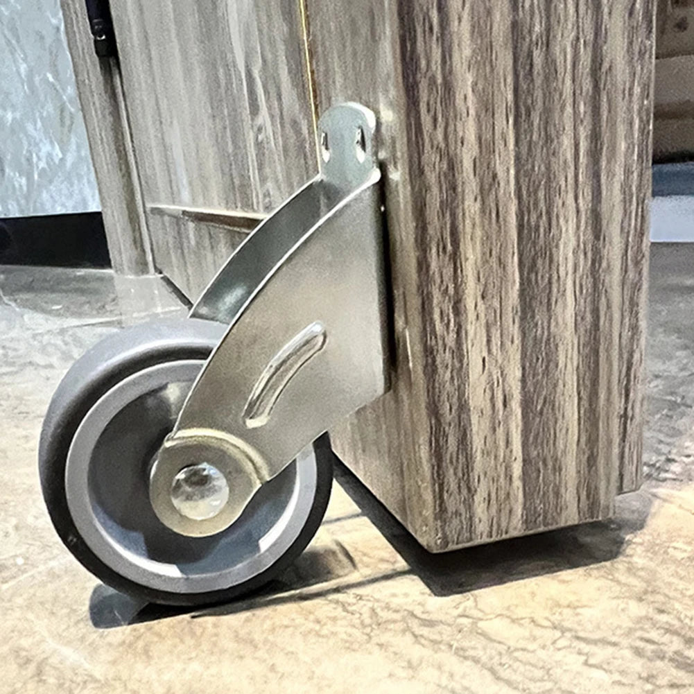 Adjustable Door Support Wheel in Gray installed beneath the edge of a wooden cabinet panel