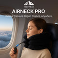 HighPeak AirNeck Pro black inflatable neck pillow with adjustable pump used by woman on airplane seat