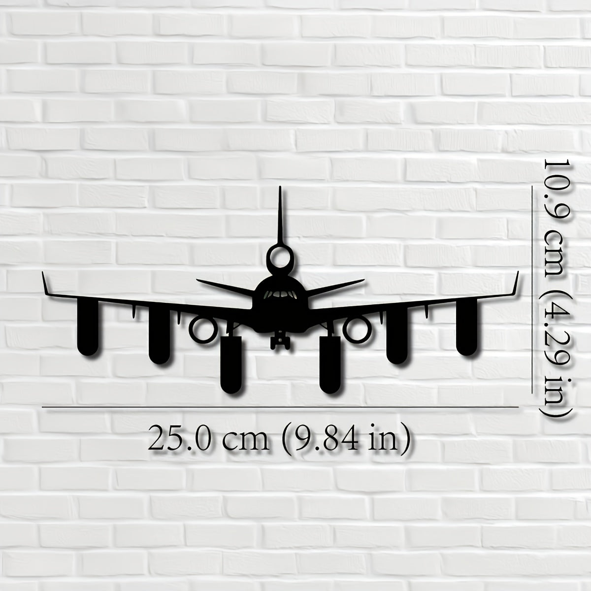 Airplane Key Holder size guide showing 25 cm (9.84 in) width and 10.9 cm (4.29 in) height on a white brick wall.