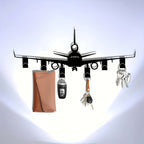 Airplane Key Holder against a white wall with cool lighting, displaying a car fob and two sets of keys.