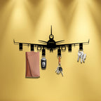 Airplane Key Holder shown on a yellow wall, with six hooks arranged beneath the black airplane silhouette.