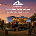 HighPeak Airstream Food Trailer with shiny stainless steel exterior serving customers at an outdoor evening event