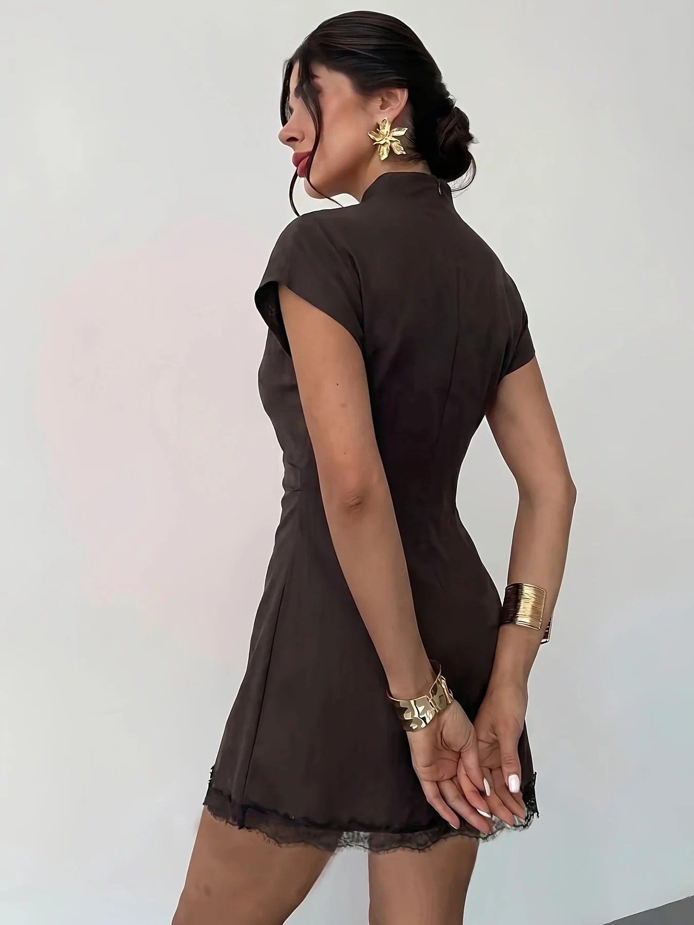 Amorette Lace Mini Dress back view showing high collar, short sleeves, fitted waist, and lace hem