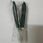 Angled Toenail Clippers in Green inside clear packaging with a translucent protective cover over the jaws.