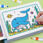 Animal Coloring Book Set blue whale and small fish on an open page being colored with a pen.