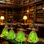 Stylized library scene showing four green glass-like broom decorations with curled black handles