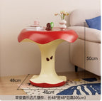 Apple Bite Side Table beside a sofa with 48 x 48 x 50 cm dimensions