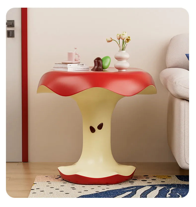 Front view of Apple Bite Side Table beside a cream sofa and door