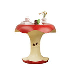 Apple Bite Side Table with books and flowers shown against a white background