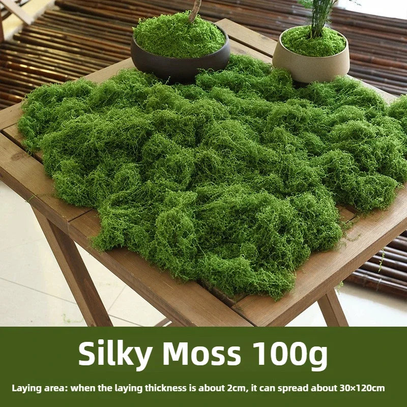 Artificial Decorative Moss spread on a wooden table beside two planters, with supplier weight and coverage guidance.