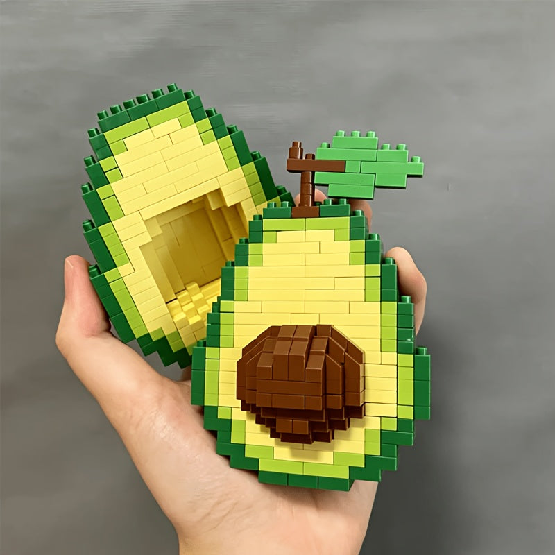 Avocado Building Block Set held in a hand with overlapping halves and the brown pit facing forward