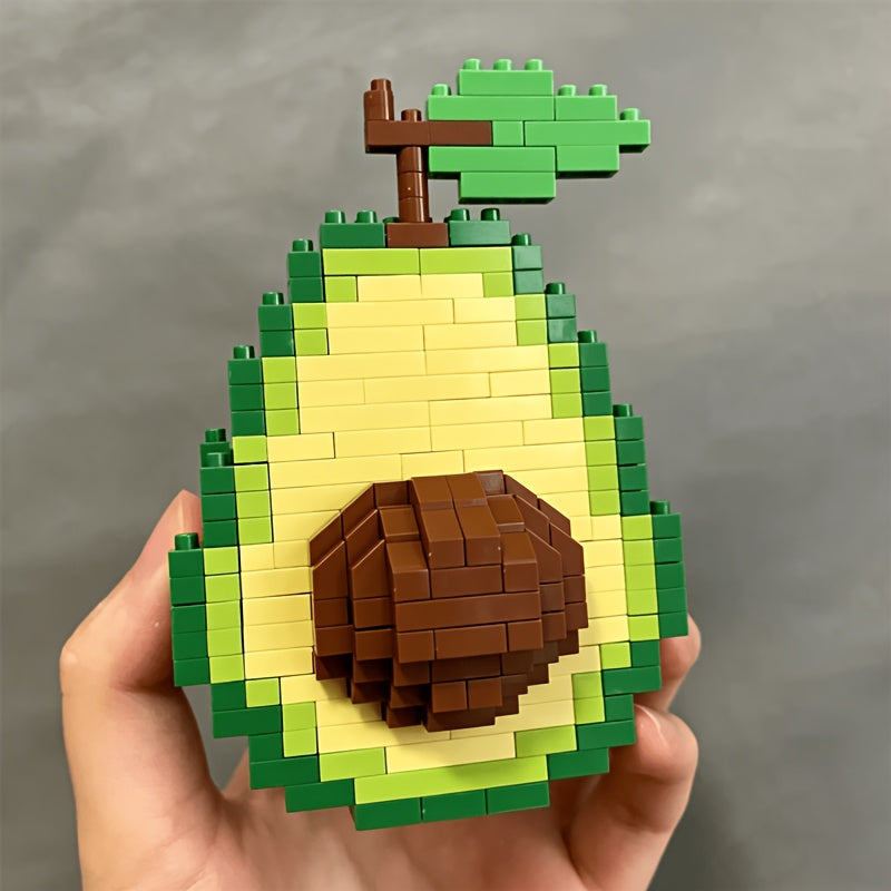 Avocado Building Block Set close-up of the brown pit, pale center, green peel, and leafy stem