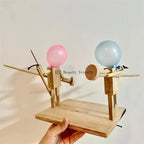 Balloon Fencing Battle Game assembled base held in one hand, showing both wooden fighters and their controls.