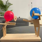 Balloon Fencing Battle Game with red and blue balloon heads facing off on a living room table.