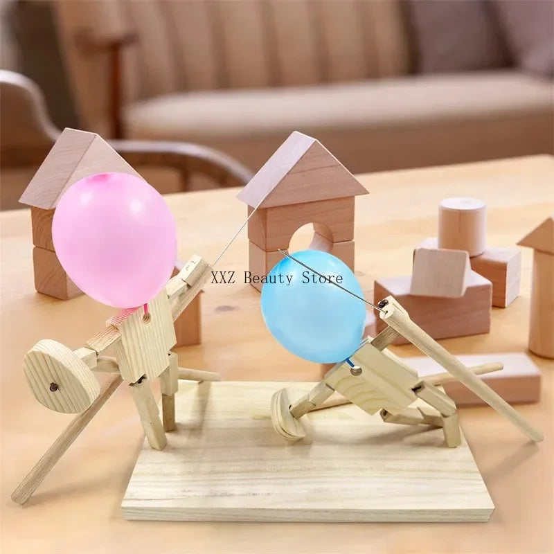 Balloon Fencing Battle Game wooden-block tabletop scene with pink and blue balloons and a supplier watermark.