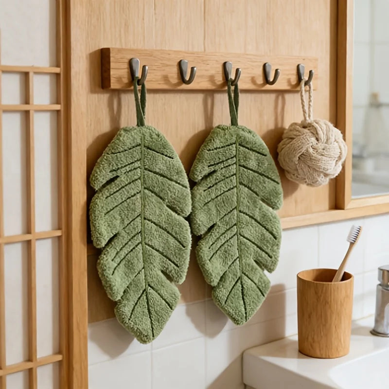 Banana Leaf Hand Towels hanging as a pair on a wooden bathroom rack