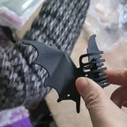 Bat Wing Claw Clip viewed from the side, revealing the curved claw teeth behind one wing.