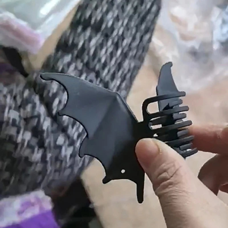 Bat Wing Claw Clip viewed from the side, revealing the curved claw teeth behind one wing.