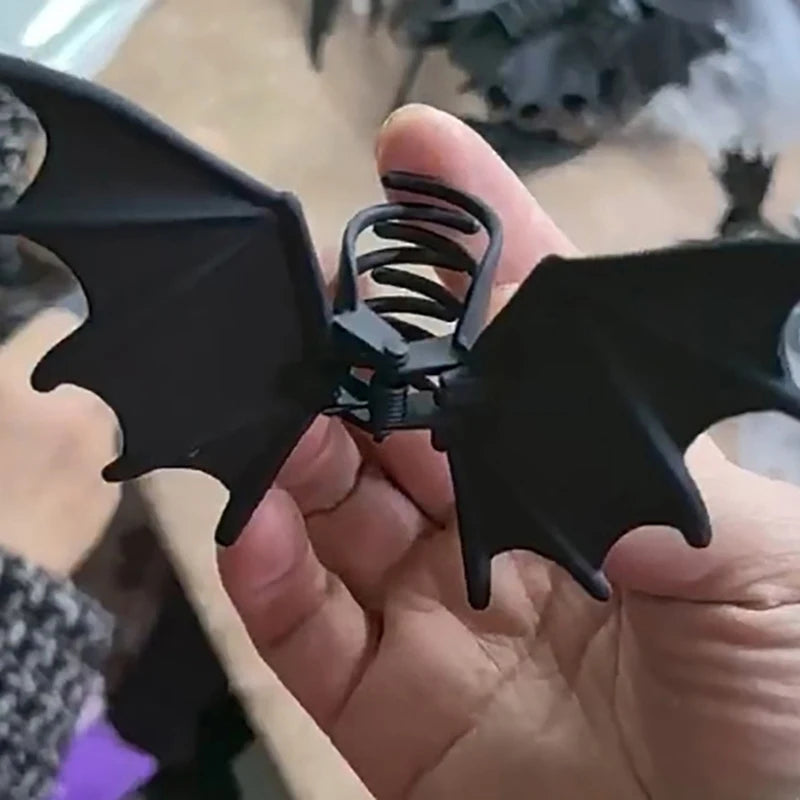 Bat Wing Claw Clip tilted in a hand to show the underside and curved teeth of the claw.
