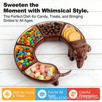 Bendy Dachshund Snack Tray curved and filled with colorful candy, chocolates, and crackers.