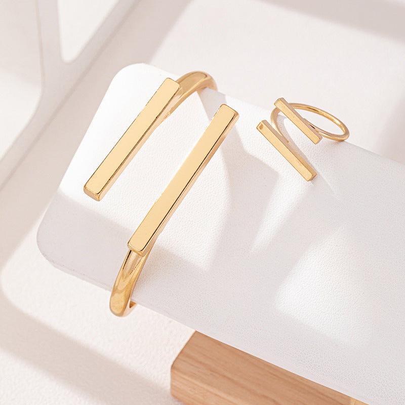 HighPeak Geometric Square Jewelry Set in gold with adjustable bracelet and ring displayed on white stand