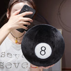 Billiard Ball Plush Set black number 8 ball held in one hand during a mirror selfie.