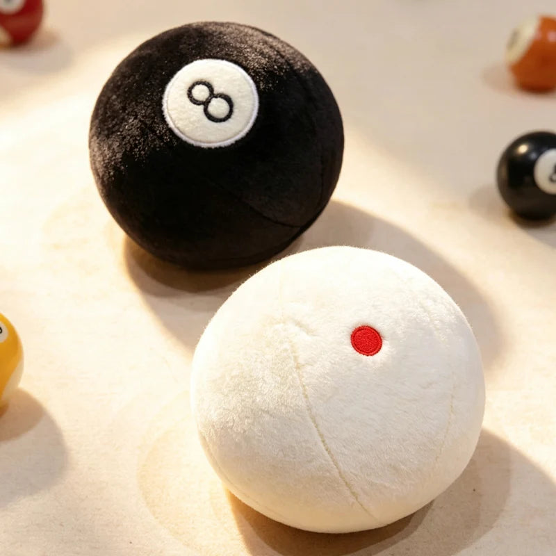 Billiard Ball Plush Set black 8 ball and white cue ball displayed in warm sunlight.